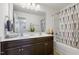 Bright bathroom with a double sink vanity, large mirror, and shower with tub at 6021 Watsonia Dr, Zebulon, NC 27597