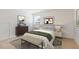 Inviting bedroom featuring two windows, stylish decor, and carpet floors at 6021 Watsonia Dr, Zebulon, NC 27597