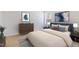 Cozy bedroom featuring a large bed, two bedside lamps, and art on the walls at 6021 Watsonia Dr, Zebulon, NC 27597