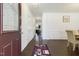 Bright foyer with dark wood floors, white walls, and an inviting view of the kitchen and dining area at 6021 Watsonia Dr, Zebulon, NC 27597