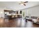 Open-concept kitchen featuring a large island, stainless steel appliances, and dark wood cabinets at 6021 Watsonia Dr, Zebulon, NC 27597