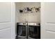 Convenient laundry room featuring a washer and dryer with shelving for extra storage space at 6021 Watsonia Dr, Zebulon, NC 27597