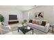 Open living room featuring a large sofa, hardwood floors, and a tv console at 6021 Watsonia Dr, Zebulon, NC 27597