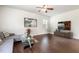 Bright living room featuring hardwood floors, stylish furniture, and a ceiling fan at 6021 Watsonia Dr, Zebulon, NC 27597