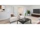 Relaxing living room features seating, neutral decor, and lots of natural light at 6021 Watsonia Dr, Zebulon, NC 27597