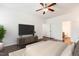 Relaxing main bedroom showcasing an en suite bathroom, tv, and neutral decor at 6021 Watsonia Dr, Zebulon, NC 27597