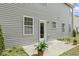A back patio provides a serene outdoor space, enhanced by potted plants and tranquil surroundings at 6021 Watsonia Dr, Zebulon, NC 27597