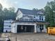 New construction home features two stories and an attached two-car garage awaiting finishing at 61 Fetterbush Way, Clayton, NC 27520