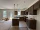 New kitchen with brown cabinets, granite countertops, and stainless steel sink at 61 Fetterbush Way, Clayton, NC 27520