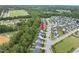 Aerial view of home nestled between lush trees and a well-maintained road at 622 Lone Pine Loop, Fuquay Varina, NC 27526