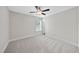 Neutral bedroom with large window, ceiling fan, carpeted floor and white trim at 622 Lone Pine Loop, Fuquay Varina, NC 27526