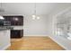Open dining area with hardwood floors and modern lighting at 622 Lone Pine Loop, Fuquay Varina, NC 27526