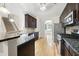 Kitchen featuring hardwood floors, granite counters, stainless appliances, and dark cabinets at 622 Lone Pine Loop, Fuquay Varina, NC 27526