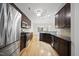Spacious kitchen featuring stainless steel appliances, dark wood cabinets, and hardwood flooring at 622 Lone Pine Loop, Fuquay Varina, NC 27526