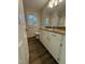 Bathroom has a vanity with storage, granite countertop, mirror and a window at 640 Crocker Rd, Smithfield, NC 27577
