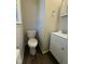This bathroom has a small vanity, toilet and dark flooring at 640 Crocker Rd, Smithfield, NC 27577