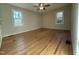 This bedroom has hardwood floors, two windows, neutral paint and a ceiling fan at 640 Crocker Rd, Smithfield, NC 27577