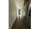Long hallway with light walls, attic access and stainless refrigerator at 640 Crocker Rd, Smithfield, NC 27577
