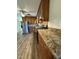 Well-lit kitchen featuring wood cabinets, granite countertops, stainless steel refrigerator, and hardwood floors at 640 Crocker Rd, Smithfield, NC 27577