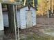 Exterior view of a dilapidated white shed with a rustic eagle decoration and surrounded by debris at 640 Crocker Rd, Smithfield, NC 27577