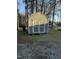 Exterior of a charming blue storage shed featuring double doors and white trim on a gravel lot at 640 Crocker Rd, Smithfield, NC 27577