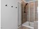 Modern bathroom features a glass-enclosed shower with a bench and a tiled accent wall at 6412 Nurture Ave, Raleigh, NC 27616