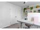 Bright bedroom featuring a closet, neutral carpet, and a modern built-in shelving unit with plants at 6412 Nurture Ave, Raleigh, NC 27616