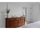 Bedroom features a wooden dresser, white walls, and a neutral color palette at 6412 Nurture Ave, Raleigh, NC 27616