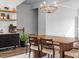 Dining area featuring floating shelves and modern furniture perfect for hosting gatherings at 6412 Nurture Ave, Raleigh, NC 27616