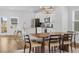 Modern kitchen with stainless steel appliances, white cabinets, and a dining table nearby at 6412 Nurture Ave, Raleigh, NC 27616