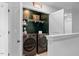 Efficient laundry area with modern washer and dryer, shelving, and storage baskets at 6412 Nurture Ave, Raleigh, NC 27616