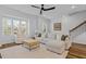 Cozy living room with a sectional sofa, large windows, and hardwood floors at 6412 Nurture Ave, Raleigh, NC 27616