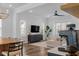 Bright living room featuring modern furnishings, a ceiling fan, and large windows at 6412 Nurture Ave, Raleigh, NC 27616