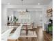 Open concept living room with wood floors and an adjacent dining area perfect for entertaining at 6412 Nurture Ave, Raleigh, NC 27616