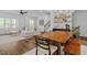 Inviting living room with a comfortable sectional sofa, wood floors, and a dining area at 6412 Nurture Ave, Raleigh, NC 27616