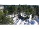An aerial view of the home on a snow-covered property surrounded by lush green trees at 6509A Fowler Rd, Zebulon, NC 27597