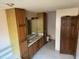 Large bathroom with dual vanities, linen closet, and a wooden door at 6509A Fowler Rd, Zebulon, NC 27597
