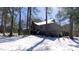 The exterior of the home is nestled among mature trees, with a light covering of snow at 6509A Fowler Rd, Zebulon, NC 27597