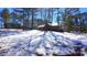 View of home with a wooded lot covered in a blanket of fresh snow at 6509A Fowler Rd, Zebulon, NC 27597