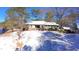 Exterior view of a home with snow-covered yard and mature trees at 6509A Fowler Rd, Zebulon, NC 27597