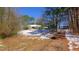 A home and carport with snow on the ground and trees in the background at 6509A Fowler Rd, Zebulon, NC 27597