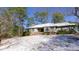 Exterior shot of the home in winter with snow on the ground and tree surround at 6509A Fowler Rd, Zebulon, NC 27597