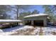 View of the home's outbuilding garage structure with snow-covered ground at 6509A Fowler Rd, Zebulon, NC 27597