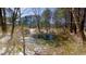 Explore this tranquil pond, partially frozen over, surrounded by snow-dusted foliage and evergreen trees at 6509A Fowler Rd, Zebulon, NC 27597