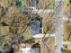 Aerial view of a home featuring a dark gray roof, surrounded by mature trees in a residential neighborhood at 7109 River Birch Dr, Raleigh, NC 27613
