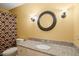 Bathroom featuring granite countertops, a decorative mirror, and modern lighting at 7109 River Birch Dr, Raleigh, NC 27613