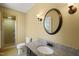 Bathroom featuring a tiled walk-in shower, a granite countertop, and a decorative mirror at 7109 River Birch Dr, Raleigh, NC 27613