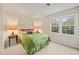 Comfortable bedroom offers a view and warm lighting from the bedside lamps at 7109 River Birch Dr, Raleigh, NC 27613