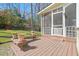 Deck features wood planking and a bench and pots of flowers at 7109 River Birch Dr, Raleigh, NC 27613