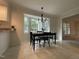Eat-in kitchen featuring a black dining table, neutral walls with white trim, and a window with backyard views at 7109 River Birch Dr, Raleigh, NC 27613